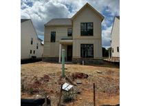 New construction two-story home features a light yellow exterior with black-framed windows and a brick foundation at 3472 Adler Trl, Buford, GA 30519