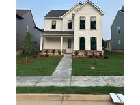 Charming two-story home with a beautifully landscaped front yard and classic white siding at 3482 Adler Trl, Buford, GA 30519