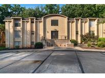 Attractive brick apartment building featuring well-maintained landscaping and a welcoming entrance at 5400 Roswell Rd # L-3, Atlanta, GA 30342