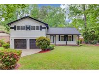 Charming two-story home with a well-maintained lawn and a two-car garage at 1728 Hudson Rd, Decatur, GA 30033