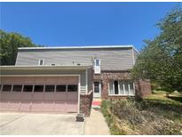 Charming two-story home with brick and vinyl siding, plus a pink two-car garage on a sunny day at 3215 Hembry Ct, Marietta, GA 30062