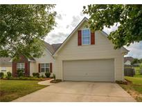 Charming home featuring a two-car garage, red shutters, and a well-maintained front lawn at 4005 Brushymill Ct, Loganville, GA 30052