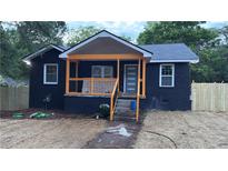 Newly renovated home with a charming front porch and modern exterior finishes and a new fence at 388 Sargent Se Dr, Atlanta, GA 30315