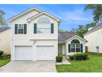 Charming two-story home featuring a two-car garage and neatly manicured lawn at 2722 South Hills, Riverdale, GA 30296