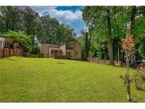 Expansive backyard with lush lawn and a charming home with a wooden deck at 2926 Swarthmore Dr, Lawrenceville, GA 30044