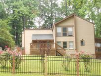 Charming home with a well-maintained lawn, black fence, and tasteful landscaping at 2926 Swarthmore Dr, Lawrenceville, GA 30044