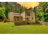 Charming two-story home featuring a wooden deck and lush green lawn at 2926 Swarthmore Dr, Lawrenceville, GA 30044
