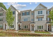 Charming townhomes with brick and siding facade, complemented by a well-maintained front lawn at 1991 Deco Dr, Kennesaw, GA 30144