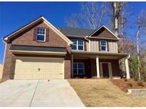 Charming two-story home with a brick and siding facade, covered entry and a two car garage at 5637 Valley Loop, Fairburn, GA 30213