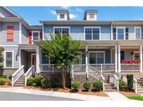 Charming townhome featuring a brick foundation, inviting porch, and well-maintained landscaping at 510 Suwanee Pass Ln, Suwanee, GA 30024