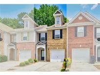 Charming townhome with brick facade, one-car garage, and well-maintained landscaping at 2457 Birkhall Way, Lawrenceville, GA 30043