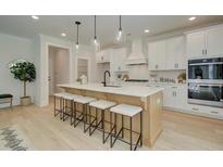 Bright kitchen features an island with seating and a suite of stainless steel appliances at 110 Prescott Manor Dr, Canton, GA 30115