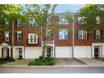 Charming brick townhomes with individual garages and well-maintained landscaping at 2108 Waters Edge Trl, Roswell, GA 30075
