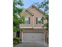 Charming two-story home featuring a brick-accented facade and a two-car garage at 7848 Rock Rose Ln, Fairburn, GA 30213