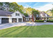 Stunning exterior shot of the house, highlighting the driveway and three-car garage at 3380 Hill Forest Nw Trl, Acworth, GA 30101