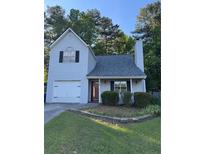 Charming two-story home with a well-maintained lawn and a traditional garage at 1034 Hillsborough Nw, Kennesaw, GA 30144