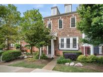 Charming townhome with stone facade, landscaped front yard, and inviting entrance at 2268 Limehurst Ne Dr # 120, Atlanta, GA 30319