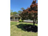 Charming single-story home featuring a well-manicured lawn and mature trees providing ample shade at 260 Amanda Ct, Stockbridge, GA 30281