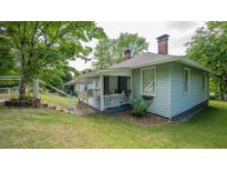 Charming home featuring a covered porch, brick chimney and large lawn at 2881 Parrott Nw Ave, Atlanta, GA 30318