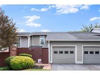 Charming townhouse with a two-car garage, well-maintained landscaping, and a private fenced entrance at 4941 Meadow Lane, Marietta, GA 30068