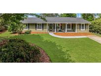 Charming single-story home featuring a well-manicured lawn and inviting front porch at 620 Clearbrook Ct, Marietta, GA 30068
