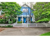 Charming blue two-story home with a white picket fence and well-maintained landscaping at 318 Glenwood Se Ave, Atlanta, GA 30312