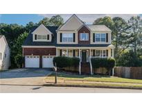Charming two-story home with a brick facade, a two-car garage, and manicured landscaping at 981 Charles Hall Dr, Dacula, GA 30019