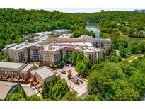 Stunning aerial view of a lakeside community with lush green trees and beautiful architecture at 200 River Vista Dr # 540, Atlanta, GA 30339