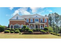 Beautiful brick home with manicured landscaping and a welcoming front porch, perfect for suburban living at 5029 Preservation Pointe, Kennesaw, GA 30152