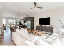 Bright open-concept living space with modern kitchen, living room and large island with barstool seating at 1371 Walking Way, Atlanta, GA 30316