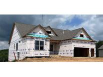 New construction home featuring gray shingles, framed windows, and a two-car garage at 235 Laurel Vista Dr, Canton, GA 30114