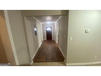 View of hallway with hardwood floors and neutral paint at 2391 Randall Ave, Lithonia, GA 30058