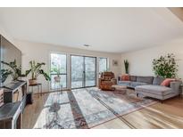 Bright living room boasts hardwood floors, neutral paint, and a sliding glass door leading to an outdoor deck at 1205 Druid Knoll Ne Dr, Brookhaven, GA 30319