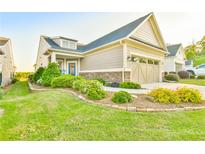 Charming home with a well-manicured lawn and attractive landscaping at 5641 Tisbury Ct, Hoschton, GA 30548