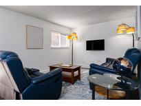 Cozy living room features comfortable blue leather seating, a sleek TV, and contemporary decor, perfect for relaxation at 381 Ralph Mcgill Ne Blvd # K, Atlanta, GA 30312