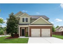 Charming two-story home with a brick facade and manicured front lawn and two-car garage at 2229 Polder Way, Austell, GA 30168