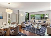 Open living room boasts large windows, hardwood floors, and modern furnishings at 1130 Piedmont Ne Ave # 410, Atlanta, GA 30309