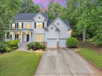 Charming two-story traditional home featuring a two-car garage, and a beautifully landscaped front yard at 115 Blue Ridge Trl, Powder Springs, GA 30127
