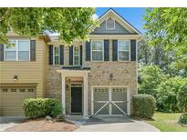 Charming two-story brick home featuring a one-car garage and a manicured front yard at 1406 Dolcetto Nw Trce # 13, Kennesaw, GA 30152