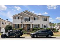 Charming two-story home with a stone facade, well-manicured lawn, and inviting curb appeal at 3811 Holliwell Pass, Cumming, GA 30040