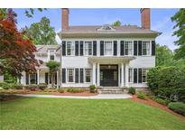 Stately two-story home with a manicured lawn and traditional architectural details like shutters and dormer window at 4356 N Buckhead Ne Dr, Atlanta, GA 30342