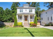 Charming two-story home with a welcoming front porch, manicured lawn, and lush landscaping at 3042 Jefferson St, Atlanta, GA 30341