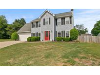 Traditional two-story home with a manicured lawn and charming curb appeal at 406 Mount Vernon Ct, Woodstock, GA 30189