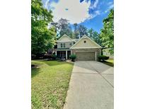 Charming two-story home with stone accents, landscaped yard, and a long driveway at 4832 Batiste Nw Ln, Acworth, GA 30101