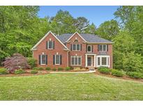Charming two-story brick home with well-kept landscaping and inviting curb appeal at 3801 Bays Ferry Trl, Marietta, GA 30062