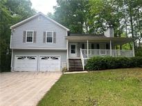 Charming two-story home featuring a welcoming front porch and an attached two-car garage at 120 Fair Havens Dr, Hiram, GA 30141