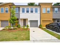 Modern townhome featuring colorful exteriors, well-manicured lawns and a private, attached garage at 1624 Gunnin Nw Trce, Atlanta, GA 30318