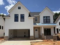 Striking two-story home with white siding, brick accents, and a spacious two-car garage at 5623 Meadowstone Walk, Kennesaw, GA 30152