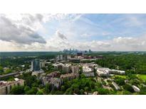 Expansive aerial view showcases the cityscape and lush green landscape of the neighborhood at 211 Colonial Homes Nw Dr # 1105, Atlanta, GA 30309