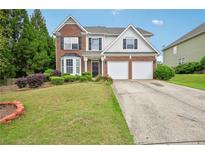 Charming two-story home with brick accents, lush lawn, and a two-car garage at 172 Mill Creek Dr, Canton, GA 30115